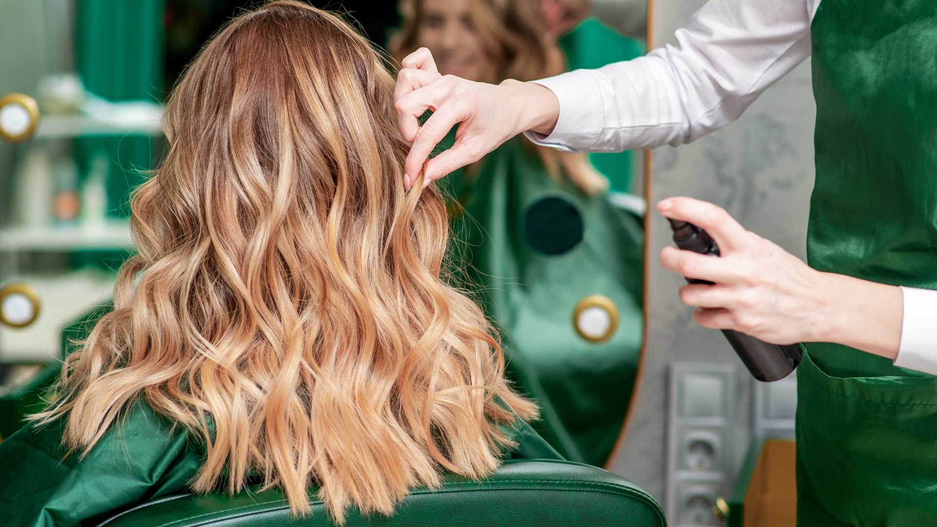 Close-up of a client's wavy, voluminous blonde balayage hair